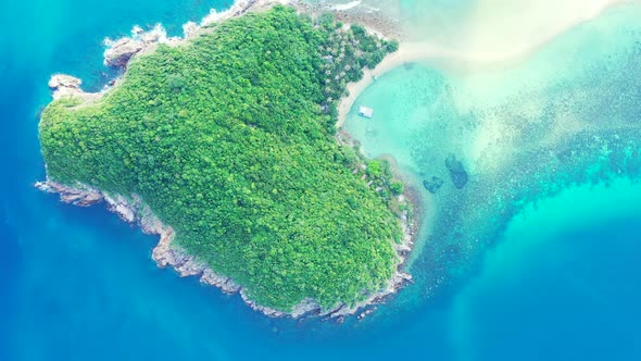 Tropical birds eye island view of a white sandy paradise beach and blue ocean background 