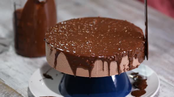 The chocolate icing on the froasted cake.Modern French mousse cake with chocolate glaze.	