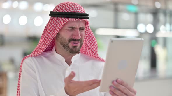 Arab Businessman Reacting To Loss on Tablet