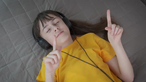 Dance with Music in Headphones in the Bed