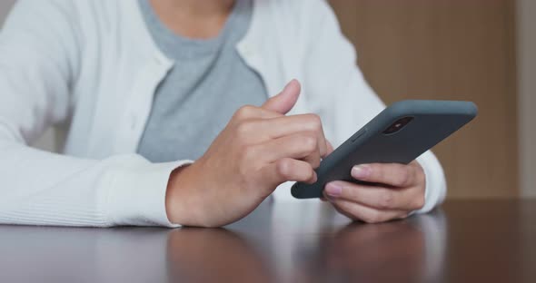 Woman use of mobile phone at home