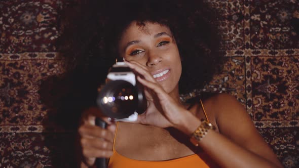 Woman With Afro Hair Using Vintage 8Mm Camera