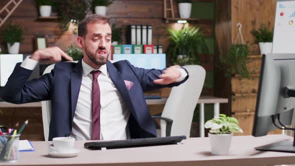 Male Business Person in Formal Suit Starts Dancing at His Desk