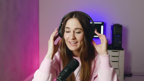 An Young Professional Female Singer is Performing a New Song with a Microphone While Recording It in