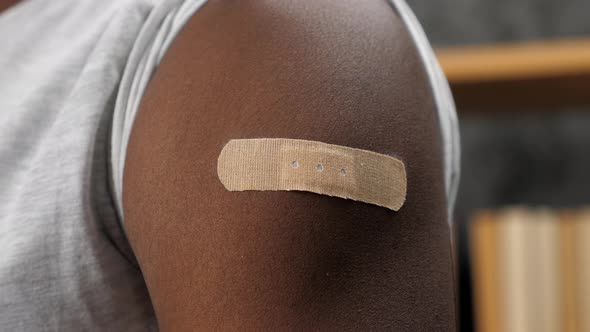 Close Up Vaccinated African American Man with Medical Plaster on Shoulder