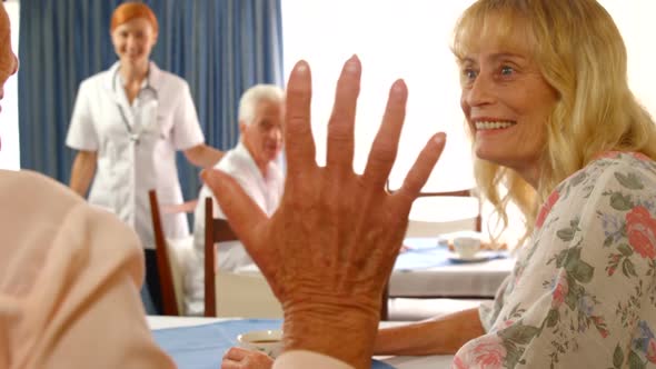 Senior woman talking to each other while female doctor walking towards them