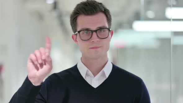 Serious Young Businessman Saying No By Finger Sign