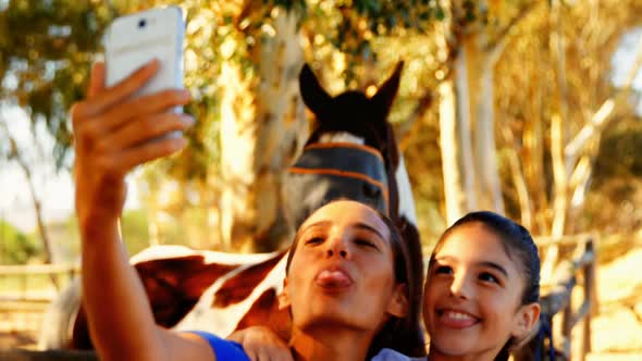 Mother and daughter taking selfie from mobile phone 4k