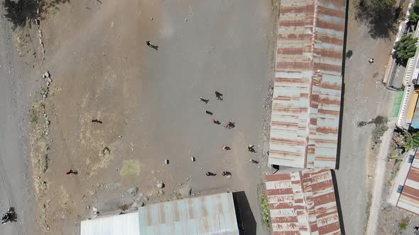 People gathering in an open space in a rural area