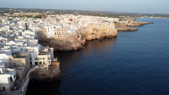 Houses and cliffs of the beautiful coastal town of Polignano a Mare, drone