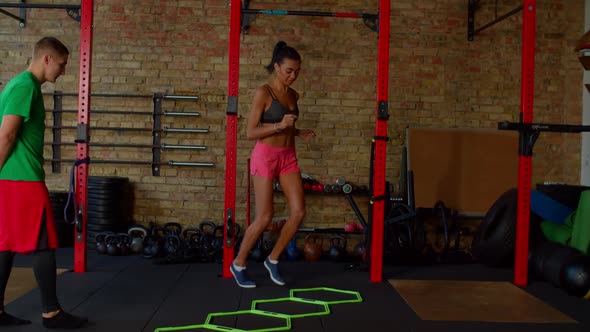 Sporty Fit African American Woman Practicing Agility Ladder in and Out Drills