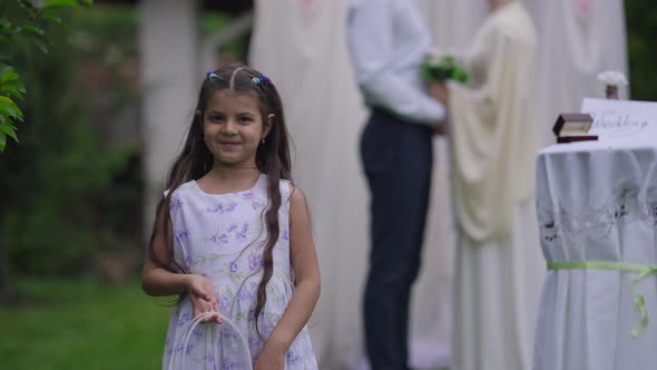 Beautiful Little Middle Eastern Smiling Girl in Dress Standing with Flower Basket on Marriage