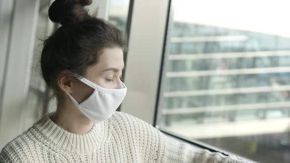 Lonely Sad Asian Girl Portrait in Medical Mask in Airport Terminal Before Flight