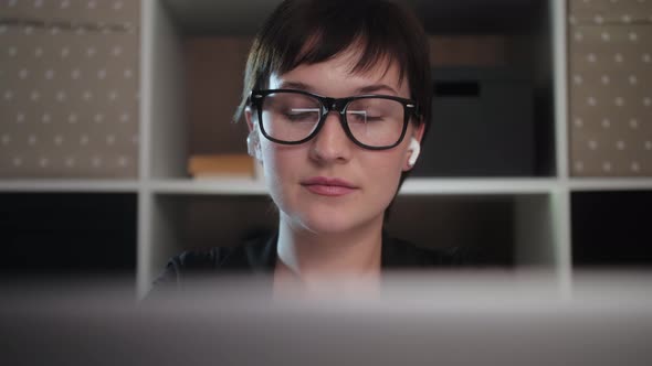 Business woman use laptop working from home in the evening. Hipster student girl.