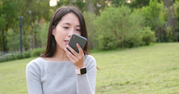 Woman using mobile phone in the park