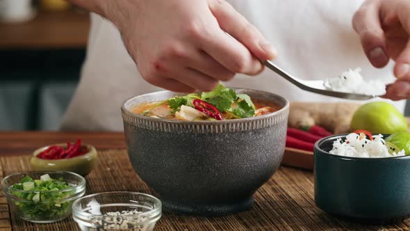 Tom Yam Kung Spicy Thai Asian Soup with Shrimp Rice Seafood Coconut Milk and Chili Pepper in Bowl