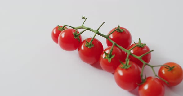 Video of fresh cherry tomatoes with copy space on white background