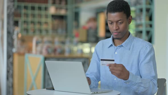 Successful Online Payment on Laptop By Young African Man