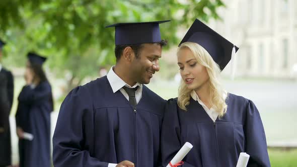 Graduate Students Looking at Cell Phone Screen and Having Talk, Posting Picture