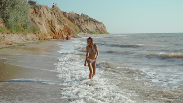 Slow Motion of Happy Joyful Woman with Perfect Slim Fitness Body Wearing in Bikini and Enjoying Wind