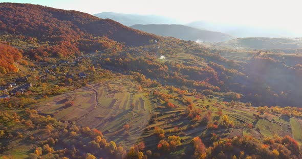 Autumn Landscape with Mountains with Small Wooden Houses in Beautiful Mountain Valley