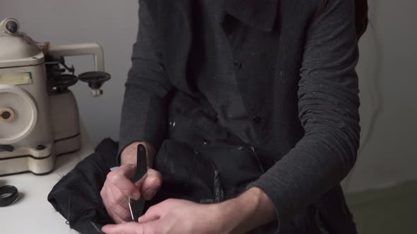 Young Handsome Male Tailor Working in Fur Workshop