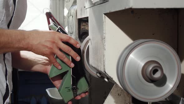 Craftsman Using Grinder Machine While Making Shoes