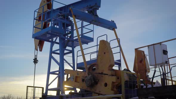Pumpjack on an Oil Well in Winter Forest in Daytime