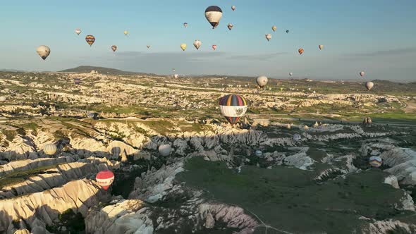 Hot Air Balloons Fly Over the Mountainous Landscape of Cappadocia Turkey