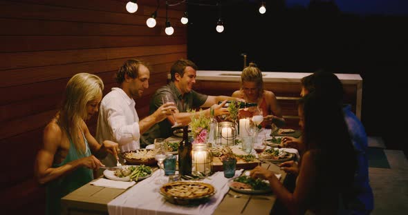 Pouring champagne at a dinner party