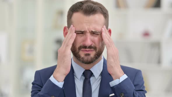 Portrait of Tired Businessman Having Headache 