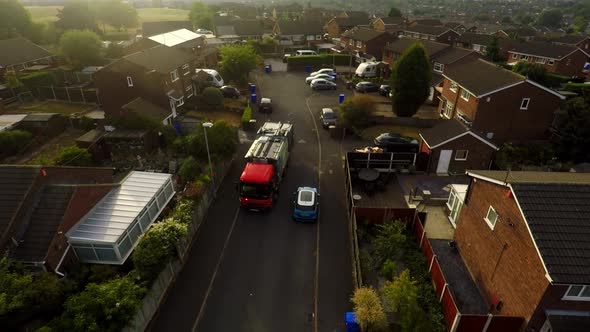 Aerial View, footage of Dustmen putting recycling waste into a garbage truck, Bin men, refuse collec