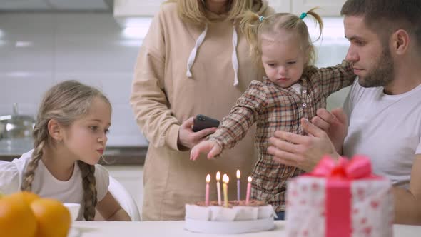 Young Caucasian Family Celebrating Sixth Birthday of Beautiful Girl at Home