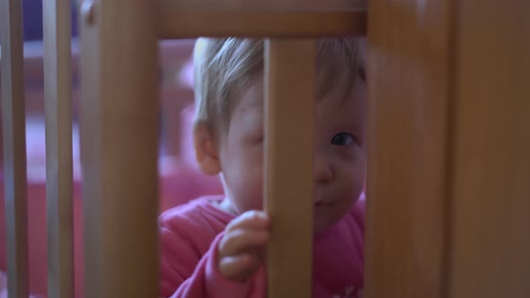 Child is Playing in His Bed Jumping Trying to Get Out 1