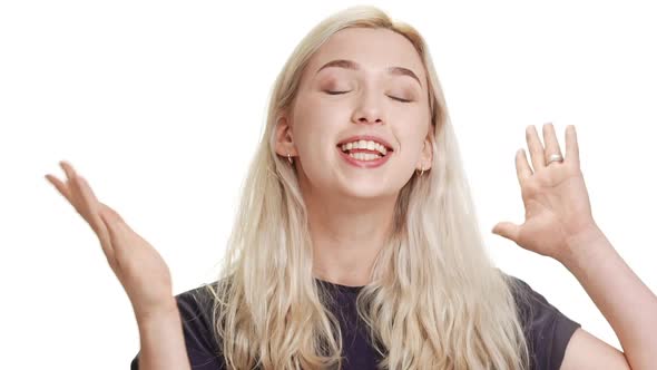 Smiling Attractive Blonde Caucasian Teenage Girl Gesturing on White Background