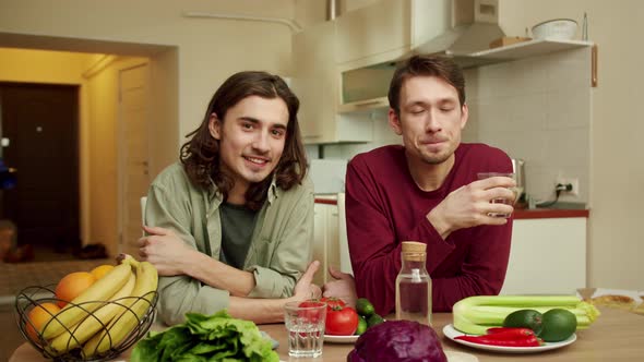 Two Men are Smiling and Looking to the Camera