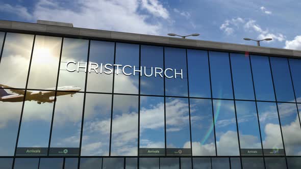 Airplane landing at Christchurch New Zealand airport mirrored in terminal