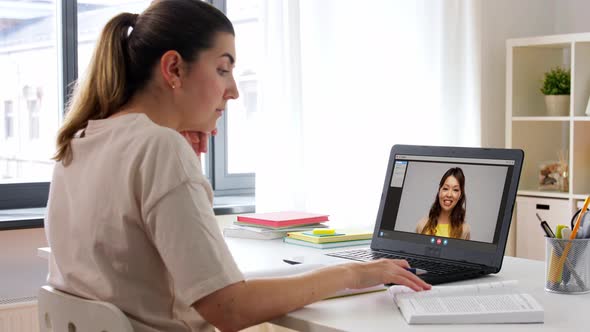 Student Woman with Laptop Watching Video at Home
