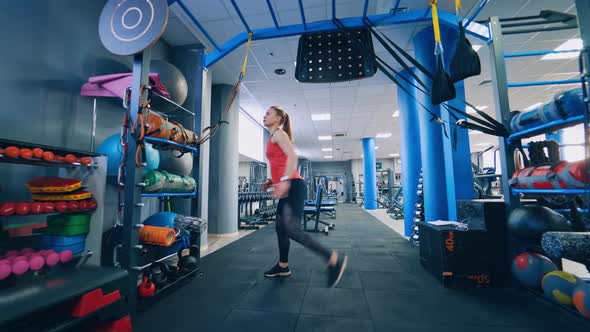 Beautiful woman working out in gym. Healthy young athletes woman doing exercises at gym