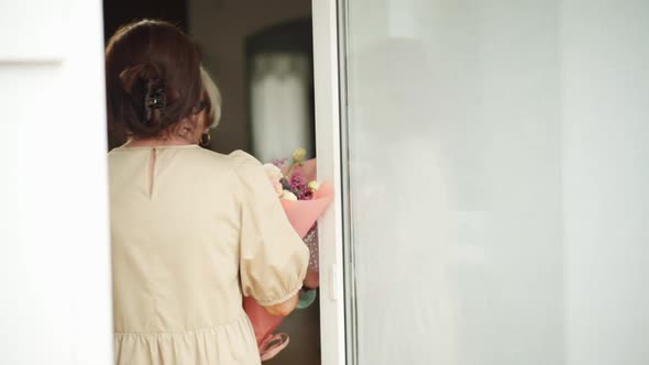 Positive Senior Caucasian Woman Greeting Friend at Home