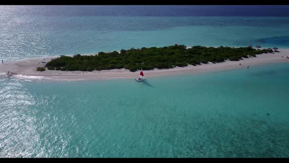 Aerial flying over panorama of relaxing shore beach lifestyle by transparent sea with white sand bac