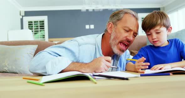 Father helping boy with homework