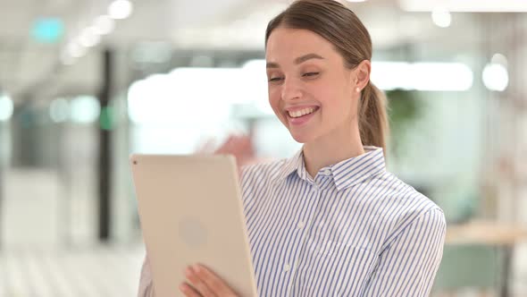 Portrait of Happy Young Woman Doing Video Call on Tablet 