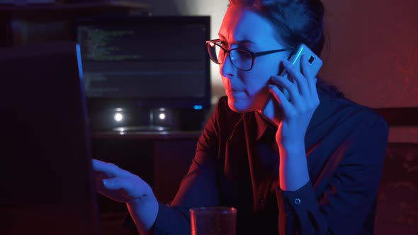 Girl at the Computer Talking on the Phone