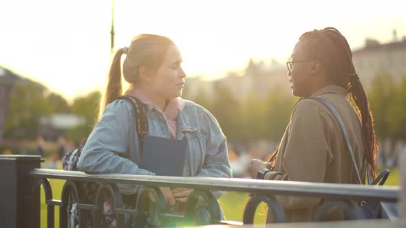 Diverse Students Women Talking To Each Other Outdoor in College Courtyard