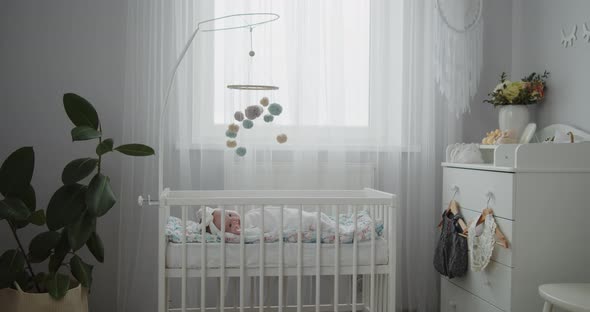 Cute Newborn Toddler Baby Lying in the Cradle in the Bright Modern Bedroom