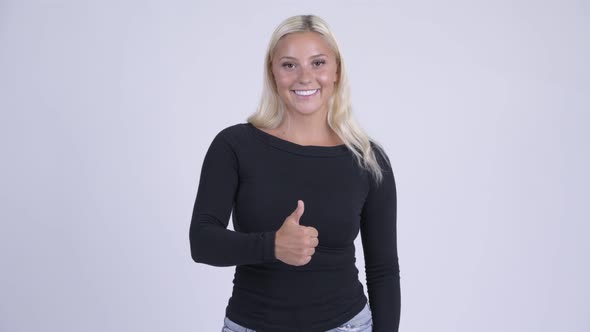 Young Happy Blonde Woman Giving Thumbs Up