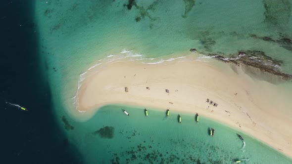Stunning aerial drone shot of an amazing, heavenly, paradisiacal sandbank beach with boats in Zanzib