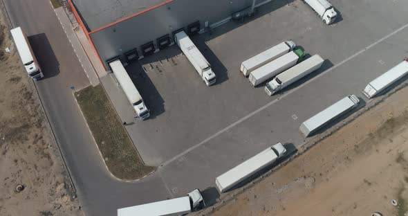 Buildings of Logistics Center, Warehouses in Field Near the Highway, View From Height, Trucks Near