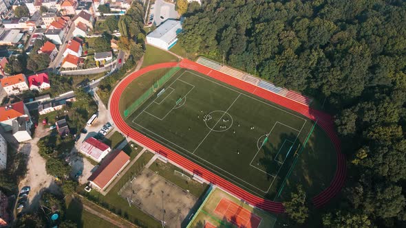 Players Play Football at Stadium Top View